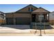 Two-story home featuring a three-car garage, covered porch, and a combination of siding and stone accents at 16113 Alpine Sorrel Dr, Monument, CO 80132