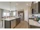 Open-concept kitchen with island, stainless steel appliances, and a view of the dining area at 16113 Alpine Sorrel Dr, Monument, CO 80132