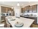 Kitchen island with a white countertop and sink with views of stainless steel appliances and brown cabinets at 16113 Alpine Sorrel Dr, Monument, CO 80132