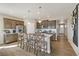 Kitchen island with a white countertop and bar stools, perfect for casual dining and entertaining at 16113 Alpine Sorrel Dr, Monument, CO 80132