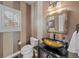 Stylish half bathroom with unique bowl sink, ornate mirror, and modern finishes at 237 Lead King Dr, Castle Rock, CO 80108