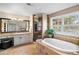 Elegant bathroom with tiled shower, soaking tub, and vanity with granite countertops at 237 Lead King Dr, Castle Rock, CO 80108