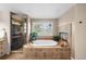 Bright bathroom featuring large soaking tub, tiled shower, and fireplace at 237 Lead King Dr, Castle Rock, CO 80108