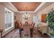 Bright dining room featuring a large window, chandelier, hardwood floors, and stylish decor at 237 Lead King Dr, Castle Rock, CO 80108
