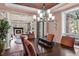 Elegant dining room with a large wooden table, chandelier, and view into the cozy living room at 237 Lead King Dr, Castle Rock, CO 80108
