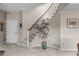Elegant foyer features a staircase with rod iron spindles, carpeted stairs, and neutral color palette at 237 Lead King Dr, Castle Rock, CO 80108