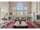 Bright and open living room with soaring ceilings, a fireplace, and large windows with scenic views at 237 Lead King Dr, Castle Rock, CO 80108