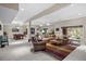 Expansive living room with neutral carpet, comfortable seating, and large windows offering natural light at 237 Lead King Dr, Castle Rock, CO 80108