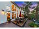 Charming patio with a dining set, lush greenery, and exterior views of the house at 237 Lead King Dr, Castle Rock, CO 80108