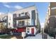 Modern three-story townhome with a red door and balcony at 2820 W 26Th Ave # 101, Denver, CO 80211