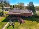 Aerial view features the property's large backyard, mature trees, covered patio, and neighborhood at 3061 S Mabry Ct, Denver, CO 80236
