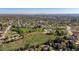 Expansive aerial view of the neighborhood with a park, city skyline, and surrounding landscape on a sunny day at 3061 S Mabry Ct, Denver, CO 80236
