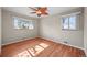 Bright bedroom with hardwood floors, two large windows, and ample natural light at 3061 S Mabry Ct, Denver, CO 80236