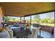 Inviting covered patio with a dining table, wicker chairs, brick accents, and a view of the backyard at 3061 S Mabry Ct, Denver, CO 80236