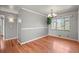 A dining room featuring beautiful hardwood floors, neutral paint, a window, and a chandelier at 3061 S Mabry Ct, Denver, CO 80236