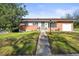 Charming single-story home featuring a walkway, manicured lawn, and beautiful landscaping at 3061 S Mabry Ct, Denver, CO 80236