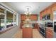 Kitchen features stainless steel appliances, granite counters, a tile backsplash, and a central island at 3061 S Mabry Ct, Denver, CO 80236