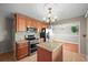 Bright kitchen features stainless steel appliances, granite counters, a tile backsplash, and a central island at 3061 S Mabry Ct, Denver, CO 80236