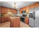 A kitchen with stainless steel appliances, granite countertops, tile backsplash, and a center island at 3061 S Mabry Ct, Denver, CO 80236