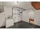 Functional laundry room with basin, storage, and dark linoleum flooring at 3061 S Mabry Ct, Denver, CO 80236
