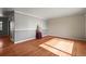 An empty living room featuring beautiful hardwood floors, neutral paint, and trim detail at 3061 S Mabry Ct, Denver, CO 80236