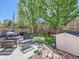 Inviting backyard with patio seating, lush landscaping, and a storage shed at 6210 Wescroft Ave, Castle Rock, CO 80104