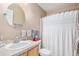 Cozy bathroom with a large, decorative mirror, neutral colored walls, and a white shower curtain at 6210 Wescroft Ave, Castle Rock, CO 80104