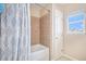 Bright bathroom featuring a shower with tiled walls and a stylish patterned shower curtain at 6210 Wescroft Ave, Castle Rock, CO 80104