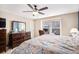 Bright bedroom with carpet, dresser, ceiling fan, and natural light from the large window at 6210 Wescroft Ave, Castle Rock, CO 80104