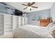 Bedroom featuring a large built-in bookshelf, tv and a bed with a ceiling fan at 6210 Wescroft Ave, Castle Rock, CO 80104
