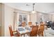 Bright dining room with a large table, wooden chairs, and natural light, perfect for Gathering gatherings at 6210 Wescroft Ave, Castle Rock, CO 80104