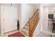 Entryway featuring a carpeted staircase and a white front door with a red patterned rug at 6210 Wescroft Ave, Castle Rock, CO 80104