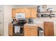 Kitchen featuring stainless steel appliances and wooden cabinets with countertop accessories at 6210 Wescroft Ave, Castle Rock, CO 80104