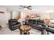 Spacious living room with a ceiling fan, plush seating, and open access to the kitchen area at 6210 Wescroft Ave, Castle Rock, CO 80104