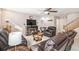Well-lit living room with a fireplace, wall decor, carpeted flooring, and comfortable leather furniture at 6210 Wescroft Ave, Castle Rock, CO 80104