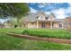Spacious backyard with a well-manicured lawn, mature landscaping, and an inviting covered patio at 4800 S Franklin St, Cherry Hills Village, CO 80113