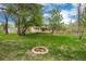 Spacious backyard with mature trees, manicured lawn and lovely fire pit at 4800 S Franklin St, Cherry Hills Village, CO 80113