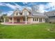 Expansive backyard featuring a covered patio and lush lawn at 4800 S Franklin St, Cherry Hills Village, CO 80113