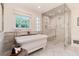 Bright bathroom featuring a soaking tub with elegant fixtures and a seamless glass shower at 4800 S Franklin St, Cherry Hills Village, CO 80113