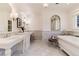 Elegant bathroom with marble floors, dual sinks, and a luxurious soaking tub at 4800 S Franklin St, Cherry Hills Village, CO 80113