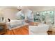 This bright bedroom boasts hardwood floors, custom lighting fixtures, and unique, mirrored built-in storage at 4800 S Franklin St, Cherry Hills Village, CO 80113