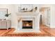 Elegant stone fireplace and hardwood floors adds architectural detail and warmth to the living space at 4800 S Franklin St, Cherry Hills Village, CO 80113