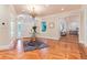Bright foyer featuring decorative wood floor pattern, chandelier, and open access to adjacent living spaces at 4800 S Franklin St, Cherry Hills Village, CO 80113