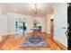 Elegant foyer featuring hardwood floors, stylish area rug, chandelier, and access to multiple rooms at 4800 S Franklin St, Cherry Hills Village, CO 80113