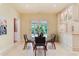 Kitchen dining area features a glass table with woven chairs, french doors leading to outside, and white cabinets at 4800 S Franklin St, Cherry Hills Village, CO 80113