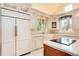 Well-appointed kitchen featuring custom cabinets, farmhouse sink, modern appliances, and ample counter space at 4800 S Franklin St, Cherry Hills Village, CO 80113