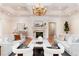 Bright living room featuring coffered ceilings, a fireplace, hardwood flooring and comfortable seating arrangements at 4800 S Franklin St, Cherry Hills Village, CO 80113