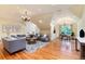 Expansive living room with elegant chandeliers, hardwood floors, and a cozy seating area at 4800 S Franklin St, Cherry Hills Village, CO 80113