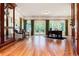 Spacious living room with hardwood floors, large windows, French doors, and built-in cabinets at 4800 S Franklin St, Cherry Hills Village, CO 80113
