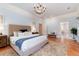 Bright and airy main bedroom featuring a cozy sitting area and a glimpse into the ensuite bathroom at 4800 S Franklin St, Cherry Hills Village, CO 80113